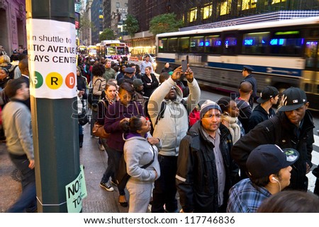 NEW YORK - NOVEMBER 2:  Commuters wait in long lines for Bus service around Grand Central post Hurricane Sandy November 2, 2012 in New York City.