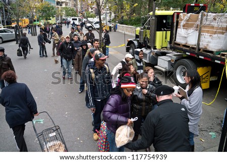 NEW YORK - NOVEMBER 2  People wait in long lines as Con Edison hands out bags of dry ice to customers with no electricity in Union Square Park November 2, 2012 in New York City.