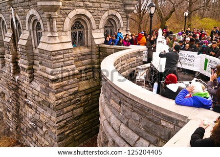 NEW YORK, NY - JANUARY 19: People watch artists sculpt an ice replica of Belvedere Castle during The Central Park Ice Festival at Belvedere Castle in Central Park January 19, 2013 in New York City.