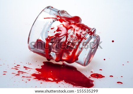 Halloween skull faced alcohol shot glass with fake blood on the outside of it