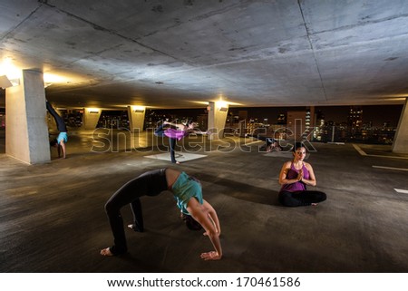 Young Woman holding yoga poses in a public space