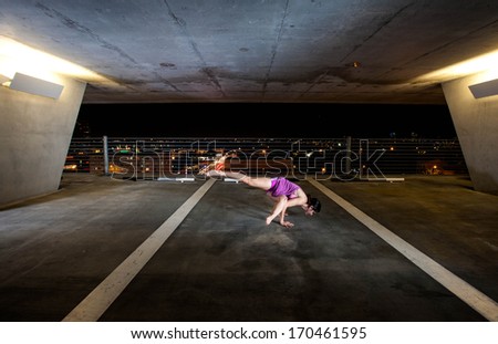 Young Woman holding yoga poses in a public space