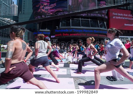 NEW YORK, NY - JUNE 21:  New Yorkers are marking the first day of summer by practicing Yoga in Times Square during the 12th annual Solstice in Times Square on June 21, 2014 in New York City.