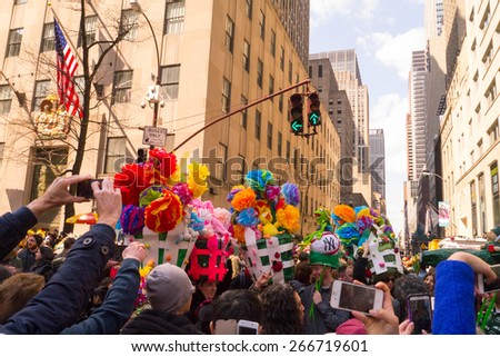 NEW YORK - APRIL 5:  A group of people with very large and creative easter bonnets pose for pictures during The 2015 Easter Parade
