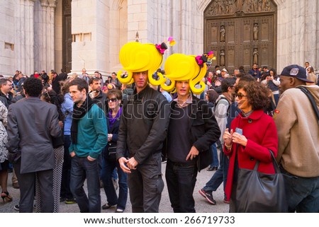 NEW YORK - APRIL 5:  Two men dressed with Yellow Easter Bonnet Hats pose in front of St. Patrick\'s Cathedral during The 2015 Easter Parade