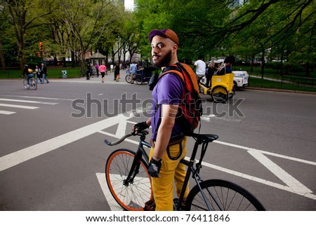 Young Man riding his bike and having fun in Central Park