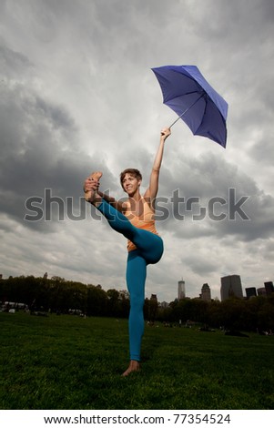 Young pretty woman in Yellow top doing yoga and exercising in Central Park