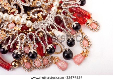 A pile of colored jewelry on white background