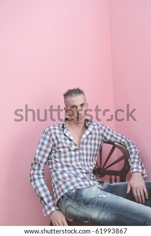 man flashed squared sitting on a chair in a relaxed way