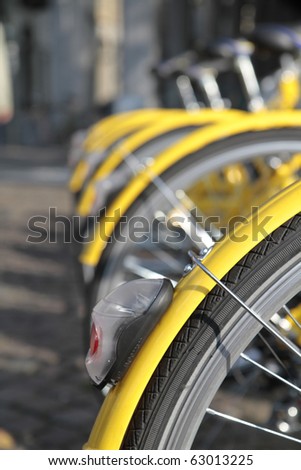 yellow bikes lined up in the city center in Turin Italy