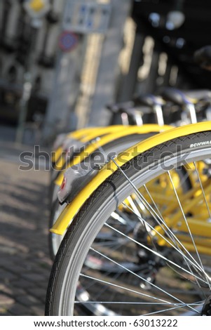 yellow bikes lined up in the city center in Turin Italy