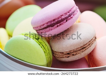 Sweet background.\
French sweets made of almond flour in a tin box