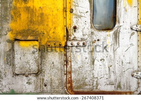 Old scratched door Fragment of an old carriage door witn small window