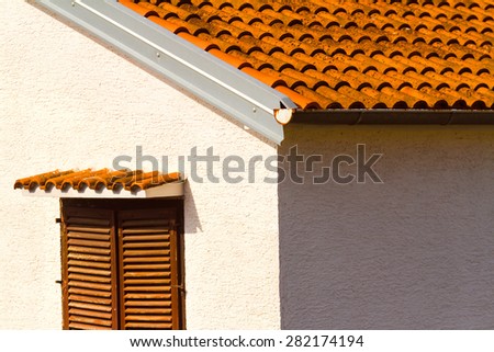 The white wall, tile red roof and the window, mediterranean architecture.