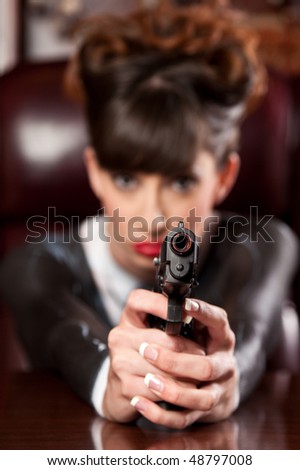 Girl in a Painted Pinstripe Suit Pointing a Gun at the Viewer.
