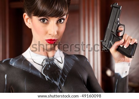 Attractive Woman in a Painted Pinstripe suit Holding a Gun.