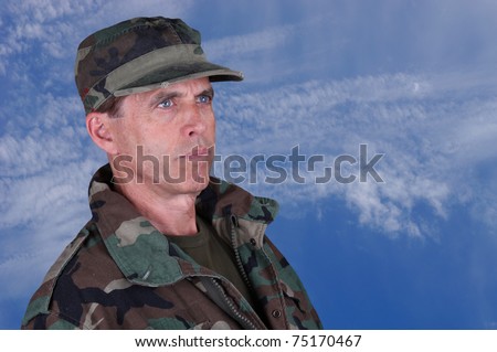 Middle aged army veteran looking up into the distance.