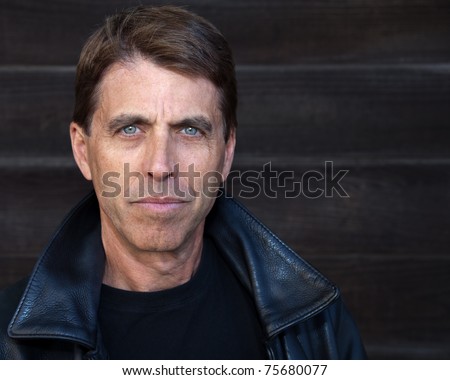 Handsome middle aged man in a leather jacket.