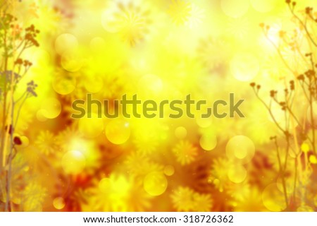 Autumn flowers sunny background. Abstract fall bokeh with lens flare effect. Beautiful fall forest with field flowers flying in the air. Blurred yellow and orange fall background with golden stardust.