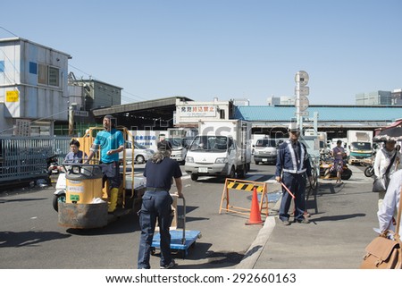 Tokyo, Tsukiji Japan -May 21, 2015 - Workers at Famous Tsukiji fish market operational area. Tsukiji is the biggest fish market in the world, with a vast varaiety of Fish and sea food.