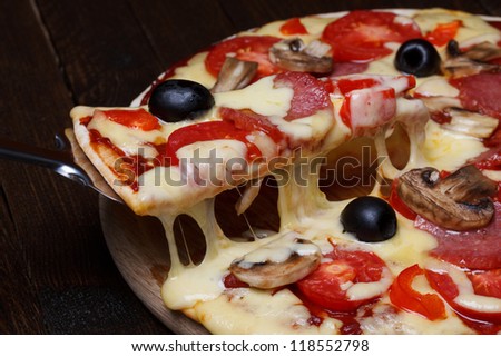 Lifted pizza slice with melting cheese