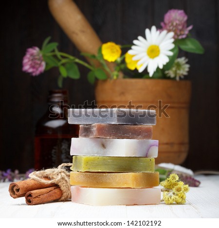 Natural different handmade soap with herbs on wooden table