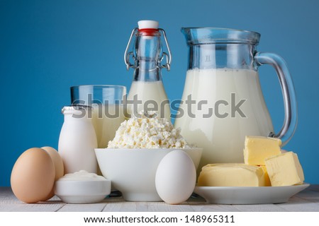 Dairy Products, Milk, Cottage Cheese, Eggs, Yogurt, Sour Cream And Butter On Wooden Table