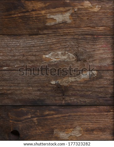 Grunge dark wood background with pieces glued paper on it