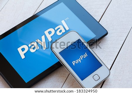 KIEV, UKRAINE - March 22: PayPal payment system logo on tablet and smarphone, in Kiev, Ukraine, on March 22, 2014.