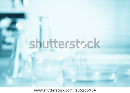 Blurred science background, test tubes and microscope with copy-space