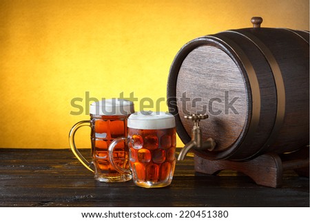 Vintage beer barrel with two beer glasses on wooden table still life with copy space