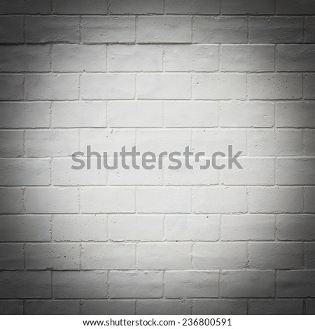 Painted white brick wall texture background, dark with light spot in center
