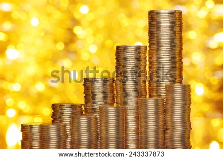 Golden coins stack with golden lights bokeh background