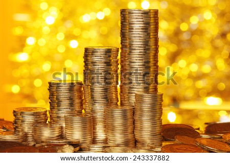 Golden coins stack with golden lights bokeh background