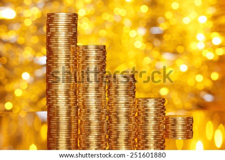Golden coins stack with reflection and golden lights bokeh background