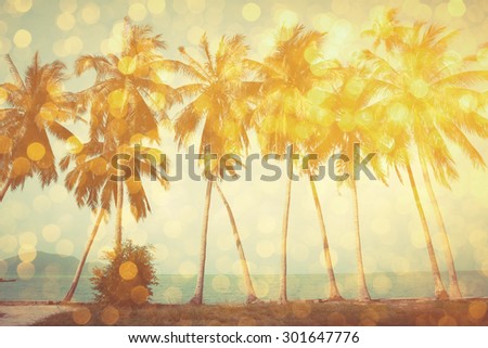Palm trees on tropical beach with golden party glamour bokeh overlay, double exposure effect stylized