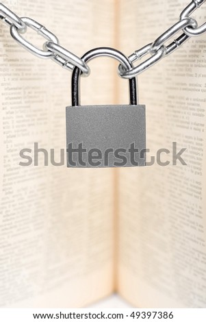 padlock with old book on background