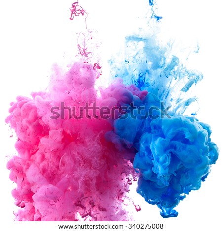 Pink and blue clouds of paint in water close-up