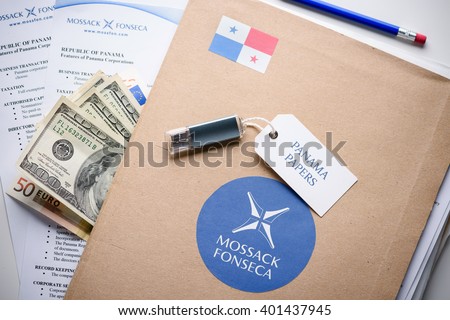 KRAKOW, POLAND - APRIL 5, 2016 : Folder with Mossack Fonseca logo and printed documents from it's web site, US and EU currency, flash drive.