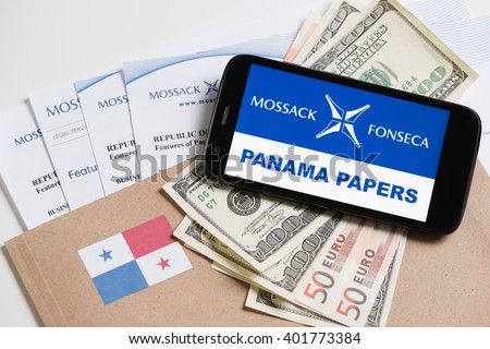 KRAKOW, POLAND - APRIL 6, 2016 : Folder with Mossack Fonseca logo and printed documents from it's web site, Panama flag, US and EU currency and phone with Panama Papers text.