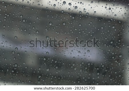 raindrop at window car on daytime that has blur background