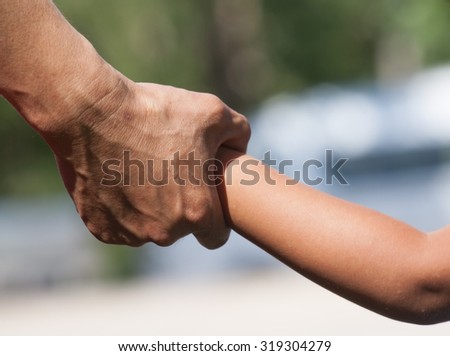 Fathers of children holding hands. Silhouettes.