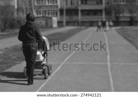 background Mom with stroller road rollers children