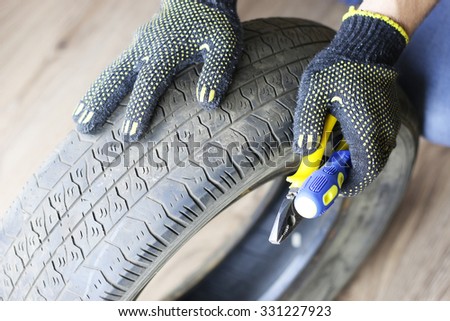 man changing tire wheels winter