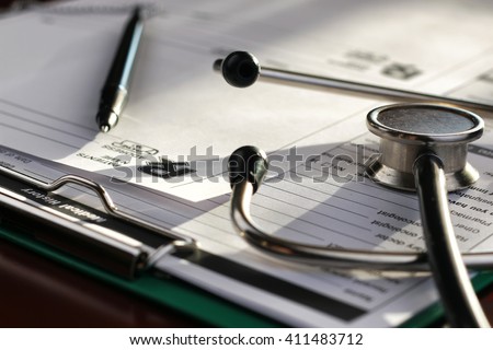 stethoscope medical documents pen
