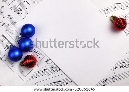 new year composition Christmas tree decorations on the table and sheet with music notes