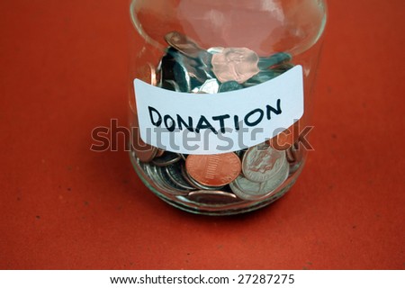 Collection of coins in a jar labeled for donation
