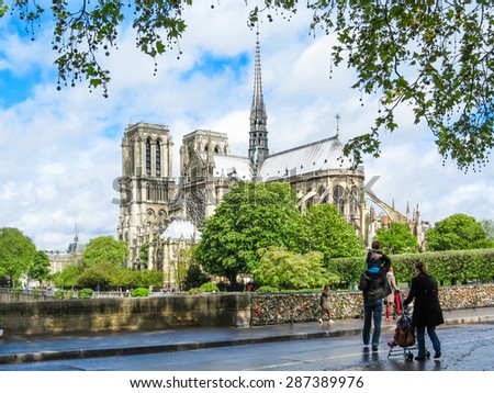 Family with children on walk across Paris. View of Notre dame de Paris, France.