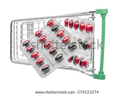 Shop cart with red-black pills blisters on an white background