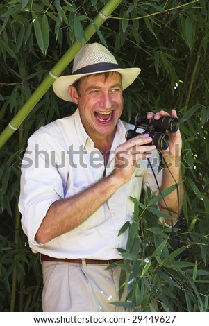 Man in jungle outfit, 1900 stile, with  binoculars